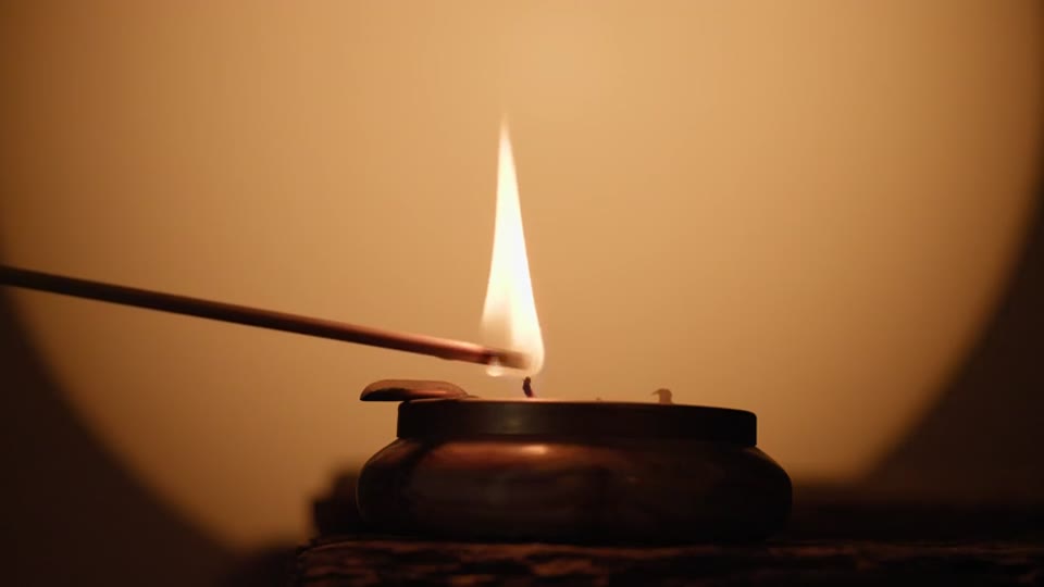 One lamp, close up, as it is lit. You see the flame