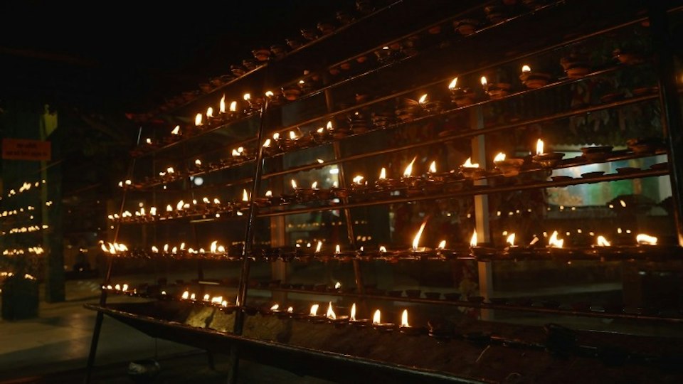 Rows of lamps being lit