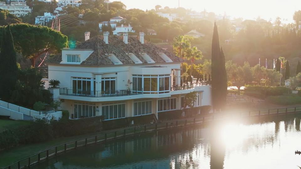Down to the house by the water, and its tall tree
