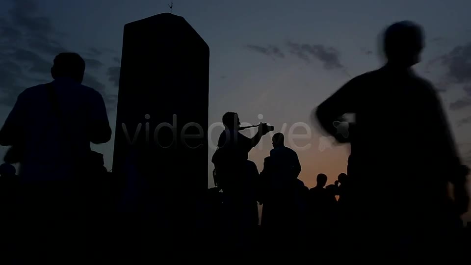 People gathered at sunrise, as one