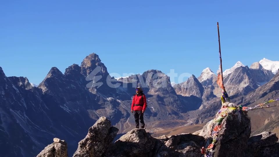 On the peak, prayer flags, mountains on every side
