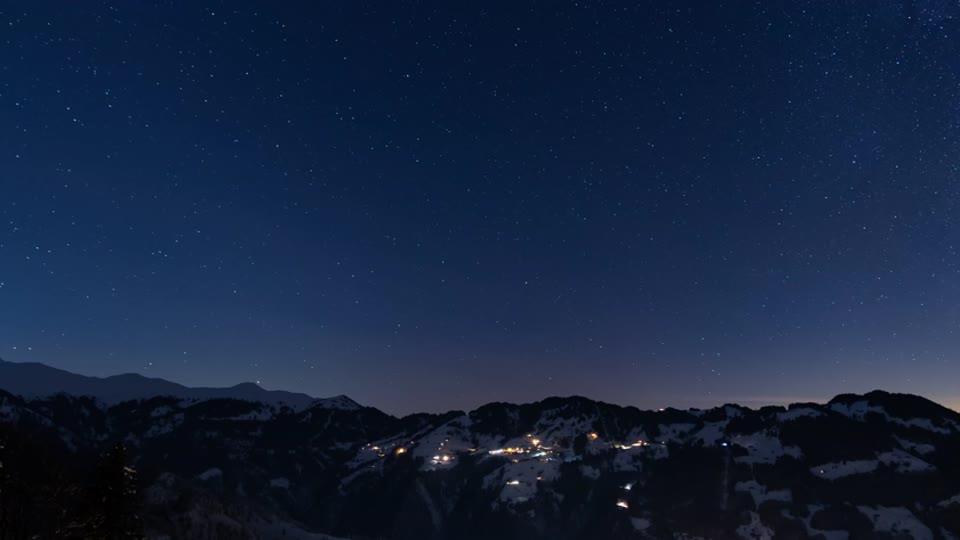 The last picture: only the night sky over the peaks, held long. Then black, then the title
