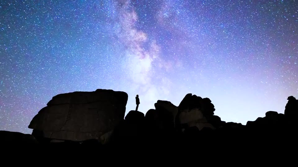 He stops under the stars and looks up
